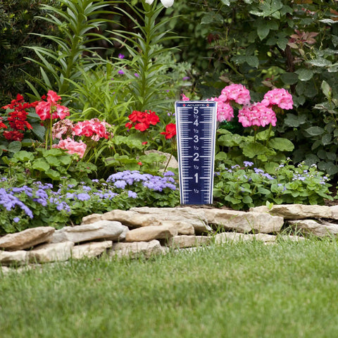 5 Inch Capacity Magnifying Rain Gauge With Easy To Read White Numbers, Acrylic Weather-Resistant Build, in a garden setting.