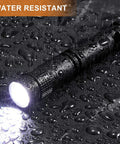 12 Pack Mini LED Pen Flashlights With Clip in rain, showcasing water resistance and illuminated beam on wet surface