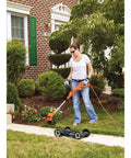 Person using 3-In-1 Electric Lawn Mower, Trimmer And Edger With 6.5 Amp Motor, 12 Inch Cutting Width in yard