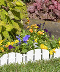 No-Dig Landscape Edging Kit With Anchoring Spikes, 4.5 Inch Tall White Wood-Look Garden Border installed around flowers