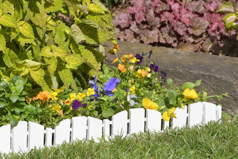 No-Dig Landscape Edging Kit With Anchoring Spikes, 4.5 Inch Tall White Wood-Look Garden Border installed around flowers