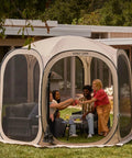 Pop Up Screen Tent Oasis 10 By 10 Ft Portable Screen Room Canopy with people inside enjoying bug-free outdoor fun, beige