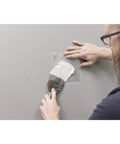 Person applying Drywall Patches Kit With Rustproof Aluminum Plate Self Adhering Mesh For Quick Wall Repairs No Pre Plaster Needed