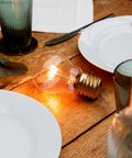 Cordless USB Rechargeable LED Light Bulb Lamp With Vintage Edison Glow Portable Bedside Night Light on wooden table
