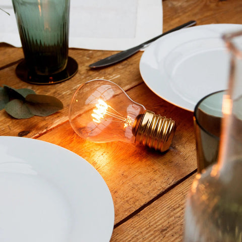 Cordless USB Rechargeable LED Light Bulb Lamp With Vintage Edison Glow Portable Bedside Night Light on wooden table