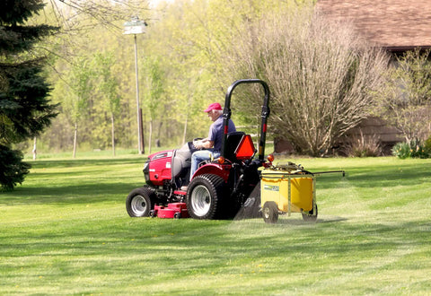 Person using 25 Gallon Trailer Sprayer For Lawn Care With 10 Inch Roll On Tires No Nonsense Tow Behind Your Riding Mower Or ATV
