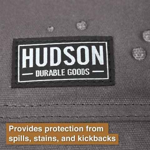 Close-up of Hudson Durable Goods logo on gray waxed canvas tool apron, showcasing spill-resistant material.