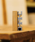 Heavy Duty 94 Inch Aluminum Multi T Track With Eight Precision Slots For Custom Jigs And Workbenches Plug And Play Build Premium 6061 T6 Anodized Made In USA showing close-up of aluminum track side view with wooden block.