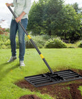 Person using Heavy Duty Lawn Leveling Rake With Stainless Steel Handle 72 Inch Yard Leveling Tool on lawn