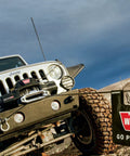 Off-road vehicle with Winch Damper With Rigging Accessory Storage Pocket And Reflective Strips For Off Road 4X4 Trucks in action.