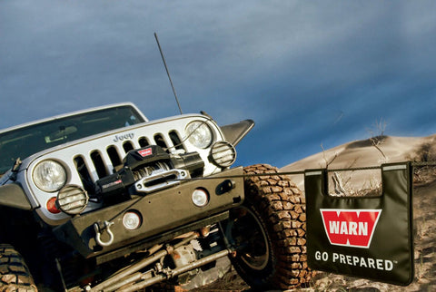 Off-road vehicle with Winch Damper With Rigging Accessory Storage Pocket And Reflective Strips For Off Road 4X4 Trucks in action.