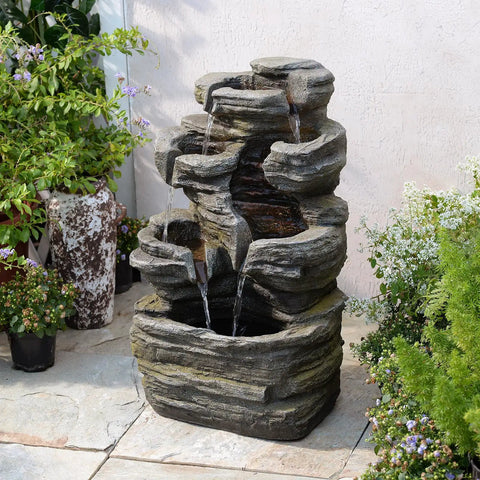 Six Tier Cascading Rock Outdoor Water Fountain With Lights For Garden Patio Backyard Deck And Porch No Fuss Setup With Pump 24.4 Inch High 110V Plug shown installed on a patio