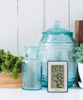 Indoor Temperature Station with Humidity Alerts For Home Comfort Real Time Temp And Humidity Readouts displayed with decor on a shelf