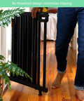 Person walking through Deluxe Stair Gate For Pets And Kids, Super Easy Install No Fuss Secure Build, Black Wood, 32 inches tall