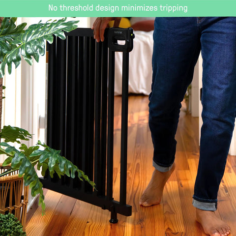 Person walking through Deluxe Stair Gate For Pets And Kids, Super Easy Install No Fuss Secure Build, Black Wood, 32 inches tall