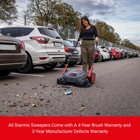 Heavy Duty Turbo Hand Sweeper With Dual Disc Brushes And Beltless Drive Works Like A Super Champ Crushing Fine Dust And Grime Across A 75 Centimeters Sweep Path in use in a parking lot.