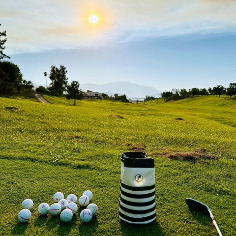 Premium Leather Golf Valuables Pouch With Drawstrings And Removable Marker on a golf course with balls and club