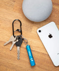 G-Series Dual Chamber Carabiner Size 3 One Pack Black Grab-And-Go Key Clip With Dual Gates next to smartphone and keys on table