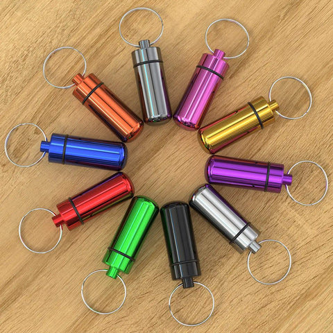 10 Pack Portable Aluminum Pill Case With Keychain, Waterproof Airtight Metal Mini Box For Outdoor Camping Travel displayed on wood surface