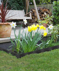 246 Ft No Dig Garden Edging Kit With 4 Inch Tall Landscape Border around flower bed in yard with white and yellow flowers
