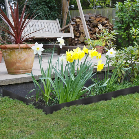 246 Ft No Dig Garden Edging Kit With 4 Inch Tall Landscape Border around flower bed in yard with white and yellow flowers