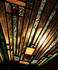 Close-up view of Two Light Tiffany Style Mission Ceiling Fixture In Blackish Bronze Finish, Innes Inspired Design with glass pieces.