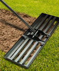 Heavy Duty Landscape Rake With 30 By 10 Inch Head And 78 Inch Detachable Stainless Steel Handle For Lawn Leveling And Yard Cleanup On Backyard Garden Golf Course Farm Pasture in use