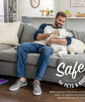 Man sitting on couch with dog, showing living space possibly cleaned with Floor Restorer And Polish Fills Scratches And Restores Shine Without Sanding For Hardwood Laminate Vinyl Tile And More Easy Mop On Application Dries In Minutes And Lasts For Months Low VOC.