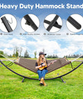 Woman sitting on Sturdy Standing Hammock With Foldable Steel Stand For Patio Or Deck, Portable 2-3 Person Hammock, easy assembly shown.