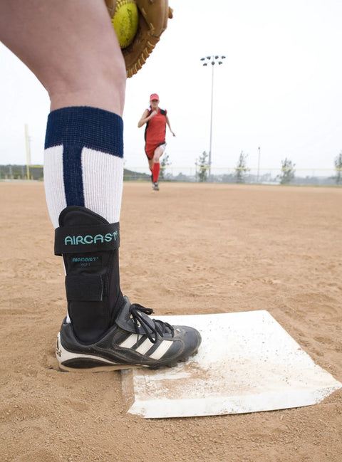 Airsport Ankle Brace With Air Cell Compression for athletes, small left fit, worn on baseball field for chronic instability support.
