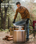 Man setting up Bonfire Cast Iron Grill Cooking Bundle 2.0 with Smokeless Fire Pit Stand in forest