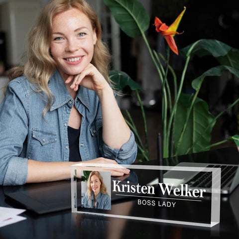 Woman sitting at desk with fully customizable desk name plate with logo upload acrylic office name plate for boss employee gifts.