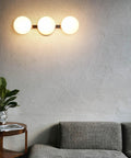 Modern 3 Light Globe Vanity Light Fixture Brushed Nickel Wall Mount Sconce with Opal Glass in living room setting