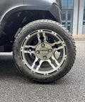 Close-up of the alloy wheel and tire of Bad Boy Six Seater Golf Cart And Sightseeing Patrol Wagon With Slick 4Kw Electric Motor And Zero Hassle 48V Lithium Battery Pack For Smooth Resort Cruising Or Tight Site Security Jobs All Week.