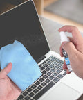 Lens and screen cleaning kit with blue microfiber cloth and spray bottle used on laptop screen