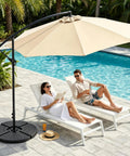 Heavy Duty Four Piece 13 Liter Water And Sand Filled Cantilever Offset Outdoor Umbrella Base Stand For Patio With Weather Resistant HDPE Construction In Black near poolside with loungers
