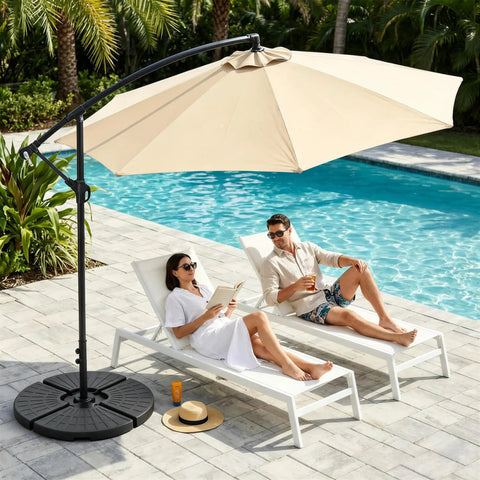 Heavy Duty Four Piece 13 Liter Water And Sand Filled Cantilever Offset Outdoor Umbrella Base Stand For Patio With Weather Resistant HDPE Construction In Black near poolside with loungers