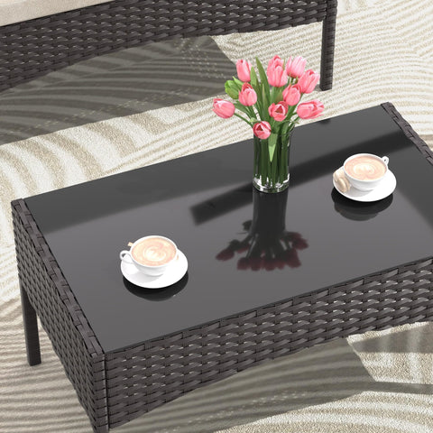 Glass coffee table from 4 Piece Wicker Patio Furniture Set with pink tulips and coffee cups, khaki finish, weather resistant