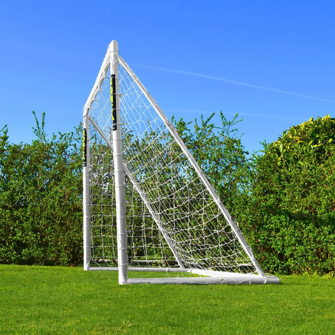 Side view of 8ft by 6ft All Weather Soccer Goal With Durable uPVC Frame, Easy Setup For Quick Play, in backyard setting.