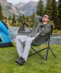 Man relaxing in Oversized Hammock Camping Chair With Adjustable Backrest For Next Level Comfort And Support 350LBS Heavy Duty Portable Folding Rocking Chair