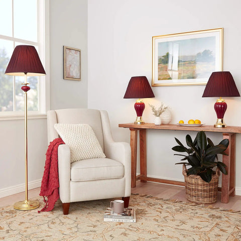 Three Lamp Set With Burgundy Ceramic And Brass Table And Floor Lamps, Includes One Floor Lamp And Two Table Lamps in a living room setting