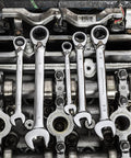 Beefy Thirteen Piece SAE Reversible Ratcheting Wrench Set With 12 Point Box Ends used on engine, showcasing durability and function.