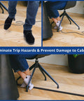 Close-up of person stepping over exposed cables and safely using 4 Foot Floor Cord Cover Black For Single Cable Hiding And Cable Management Cord Hider To Prevent Trips Wire Protector For Power Cords Ethernet And Speaker Cables On Open Floors Or Countertops.