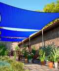 Blue 8 By 12 Foot Sun Shade Sail UPF50 Rectangle Canopy installed over patio with plants, providing breathable and water-permeable shade.