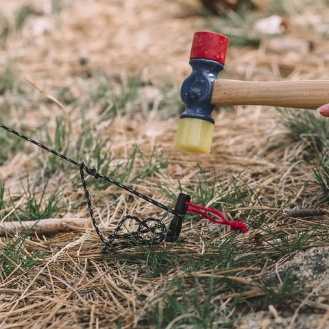 Hammer fitting a Beefy 16 Pack 7075 Aluminum Tent Stake 7.25 Inch Long Heavy Duty Ground Pegs Rust Resistant For Camping Canopy And Tarp Keeps Tents Secure In High Wind into the ground