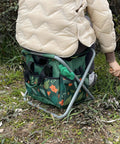 Person using Foldable Gardening Stool With Detachable Storage Tote For Gardening Camping And Fishing Tools Organizer.