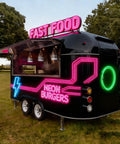 Commercial Grade Coffee Trailer And Mobile Hot Dog Cart Featuring Chef Ready Full Kitchen Setup With Plug And Play Wiring To Help You Crush Sales At Street Events in black with neon signs.