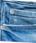 Front view of blue denim pocket with silver round rivet studs
