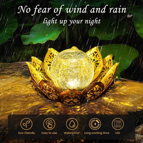 Gold Petal Lotus Flower Solar Light With Crackle Glass Globe Lit Amber Glow Outdoor Lantern under rain on garden pathway