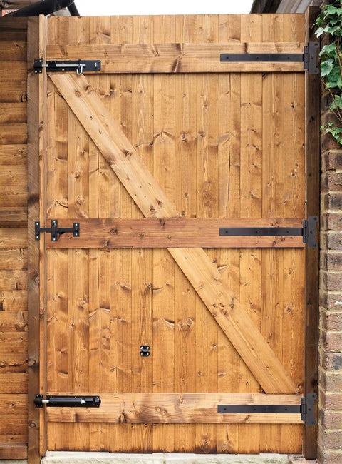 Wooden gate with 12 Inch Black Door Hinges Set For Gates And Barn Doors Includes 12 Mounting Screws And 2 Hinges Tough As Nails Heavy Duty 4mm Iron